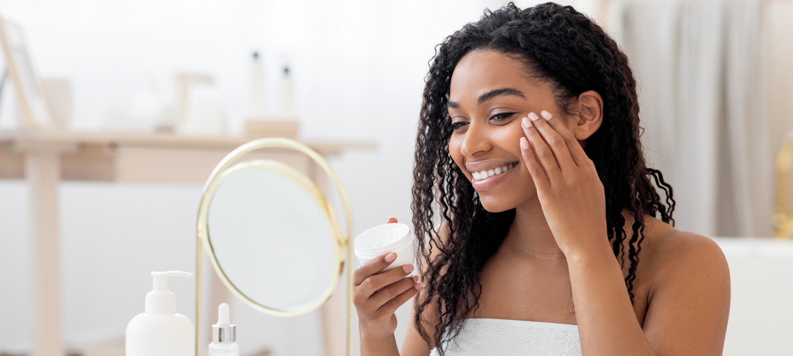 Woman applying skincare products during a beauty routine at home