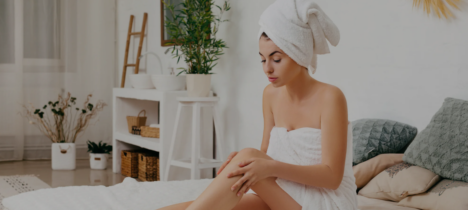 Woman applying body skincare products as part of a relaxing self-care routine